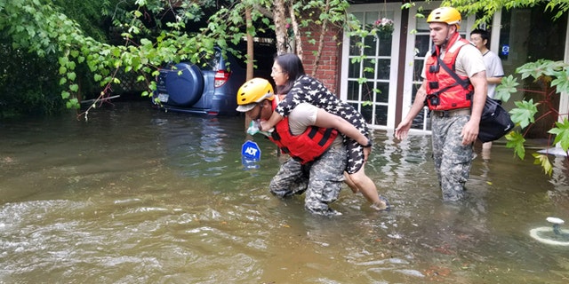 Texas National Guard soldiers aid stranded residents in heavily flooded areas of Houston, Texas, Aug. 27, 2017.