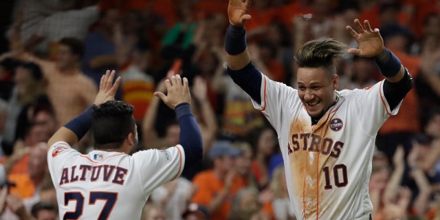 Yuli Gurriel and Jose Altuve celebrate during the Houston Astros win over the New York Yankees in Game 7 of the 2017 American League Championship Series.