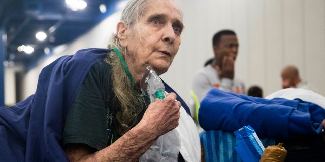 Theresa Ross receives a tank of oxygen when she arrived to the George R. Brown Convention Center seeking shelter with her husband in Houston on Monday, Aug. 28, 2017.