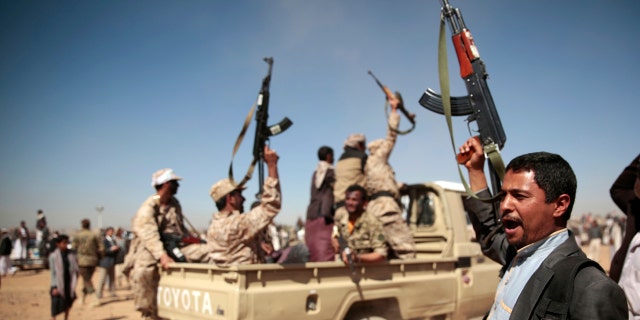 A tribesman loyal to the Houthi rebels, right, chants slogans during a gathering aimed at mobilizing more fighters into battlefronts to fight pro-government forces in several Yemeni cities, in Sanaa, Yemen.