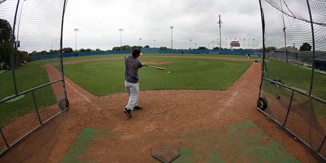 FORT WORTH - APRIL 29: Members of the Arlington Heights High School baseball team participate in a voluntary practice after state University Interscholastic League officials announced a delay until May 11 for all Texas high school sport and academic events as a precaution against the swine flu April 29, 2009 in Fort Worth, Texas. Members of the baseball team were given the option to workout on their own after the day's practice was cancelled. (Photo by Tom Pennington/Getty Images)