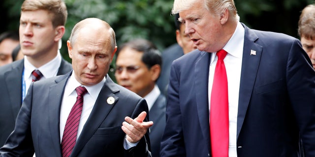 Nov. 11: U.S. President Trump and President Putin talk during the family photo session at the APEC Summit in Danang, Vietnam.