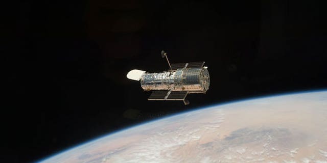 The Hubble Space Telescope orbits high above the Earth, after it was released at the close of the STS-125 servicing mission.