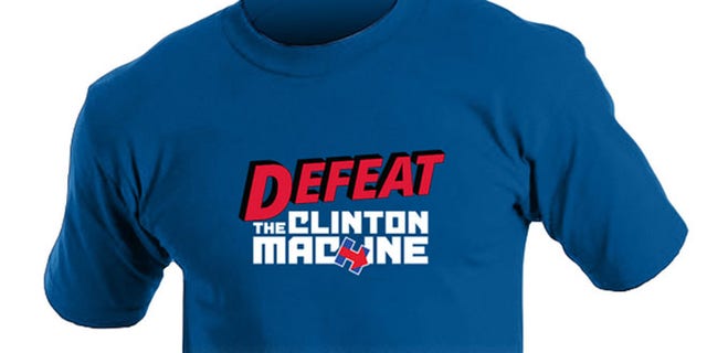 The former Arkansas governor gets in on the act with a comic-book style T-shirt, labeled “Defeat the Clinton machine” ($19).