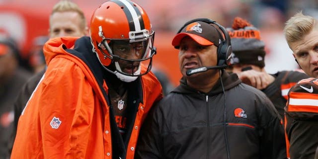 Cleveland Browns head coach Hue Jackson, right, talks with quarterback Robert Griffin III in the first half of an NFL football game against the San Diego Chargers, Saturday, Dec. 24, 2016, in Cleveland. (AP Photo/Ron Schwane)