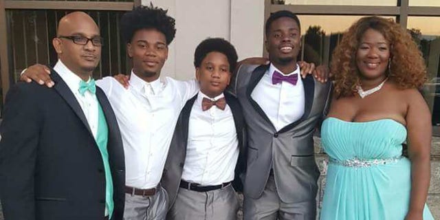 Williams, 37, left, with his three children and wife.