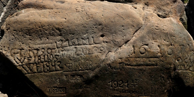 One of the "hunger stones" exposed by the low level of water in the Elbe River is seen in Decin, Czech Republic, Thurs., Aug. 23, 2018.