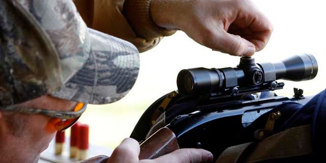 In this file photo, a hunter dials in his scope at a firing range in Joliet, Ill,