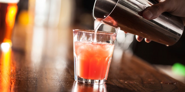 Bartender serving a cocktail from a shaker