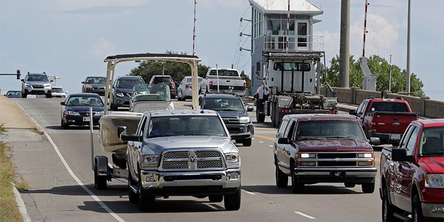 People drive over a drawbridge in Wrightsville Beach, N.C., as they evacuate the area in advance of Hurricane Florence on Tuesday.
