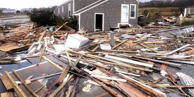 Oct. 30, 2012: Debris floats around a house pushed off its foundation in the aftermath of superstorm Sandy in East Haven, Conn.