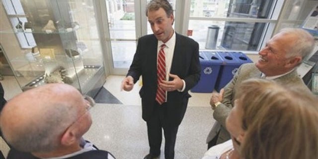 Virginia state Sen. Robert Hurt, center, talks to constituents prior to the start of a dinner at the Virginia Museum of Natural History in Martinsville, Va., July 13. (AP Photo)