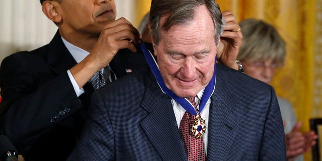 Former President George H.W. Bush is awarded the Medal of Freedom by then-President Barack Obama.