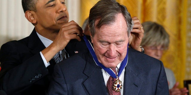 Former President George H.W. Bush is awarded the Medal of Freedom by then-President Barack Obama.