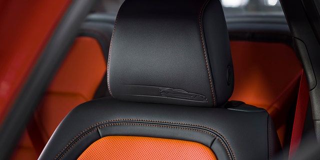 The interior gets orange upholstery and seat belts.