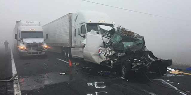 In this photo provided by the Arizona Department of Public Safety, vehicles remain at the scene of a traffic accident along Interstate 40 on Wednesday, Oct. 19, 2016, in northern Arizona near Parks, Ariz. S