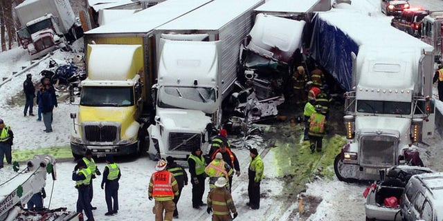 Jan. 23, 2014: In this photo provided by the Indiana State Police, emergency crews work at the scene of a massive pileup involving about 15 semitrailers and about 15 passenger vehicles and pickup trucks along Interstate 94.