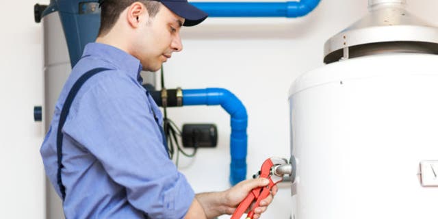 Technician repairing an hot-water heater