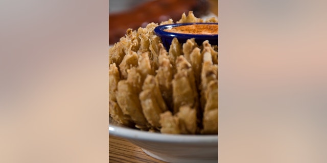 deep fried onion flower with dipping sauce