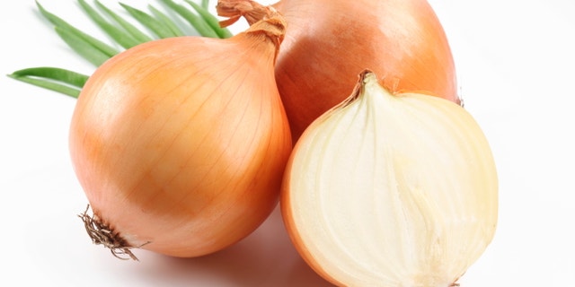 Fresh bulbs of onion on a white background