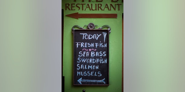 A chalkboard menu showing specials outside of a seafood restaurant in Prague, Czech Republic