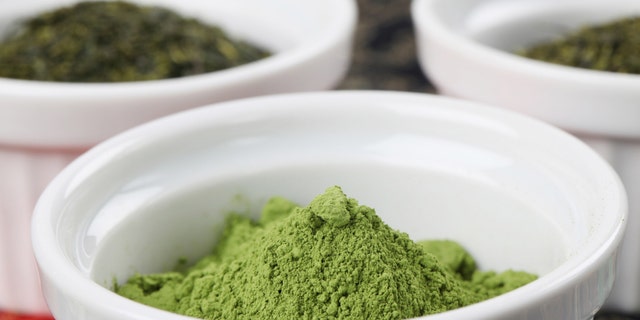 White bowls with green teas - focus on matcha green tea powder