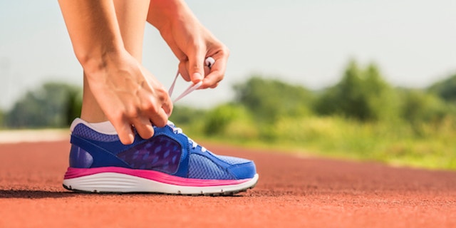 tying shoes at starting line