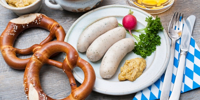 Bavarian meal. White sausages with sweet mustard and pretzels