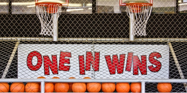 A basketball game of chance on a boardwalk