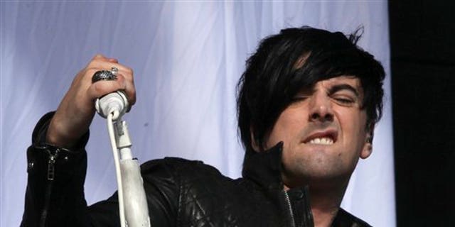 FILE - This is a Saturday, Aug 20, 2011 file photo of British musician Ian Watkins, lead singer of Lostprophets, as he  performs on stage at V Music Festival in Hylands Park, Chelmsford, England Watkins pleaded guilty on Tuesday Nov. 26. 2013 to a series of sexual offenses, including trying to rape a baby. Watkins, 36, was arrested last December and charged with more than 20 offenses, including raping a baby, conspiring to sexually assault a child and and making indecent images.  (AP Photo/Joel Ryan, File)