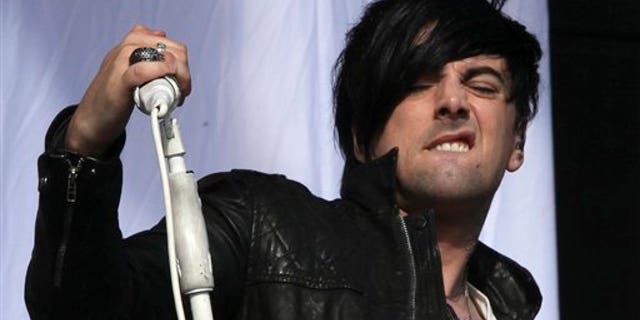 FILE - This is a Saturday, Aug 20, 2011 file photo of British musician Ian Watkins, lead singer of Lostprophets, as he performs on stage at V Music Festival in Hylands Park, Chelmsford, England Watkins pleaded guilty on Tuesday Nov. 26. 2013 to a series of sexual offenses, including trying to rape a baby. Watkins, 36, was arrested last December and charged with more than 20 offenses, including raping a baby, conspiring to sexually assault a child and and making indecent images. (AP Photo/Joel Ryan, File)