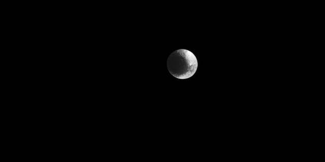 Saturn's unusual moon Iapetus, as captured by the Cassini spacecraft March 11. Features in the image are visible at a scale of about 9 miles (15 kilometers) per pixel.