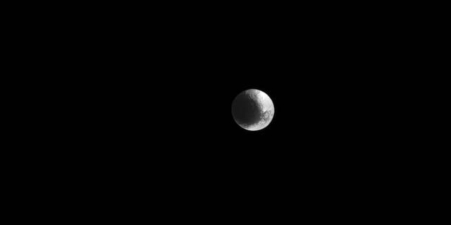Saturn's unusual moon Iapetus, as captured by the Cassini spacecraft March 11. Features in the image are visible at a scale of about 9 miles (15 kilometers) per pixel.