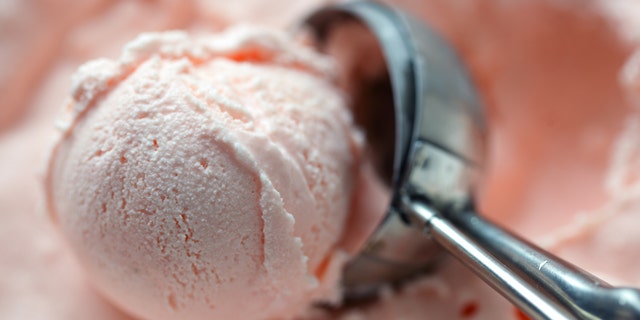 Ice cream pink fruit with a spoon
