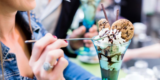 Couple enjoying an ice cream sundae in cafe