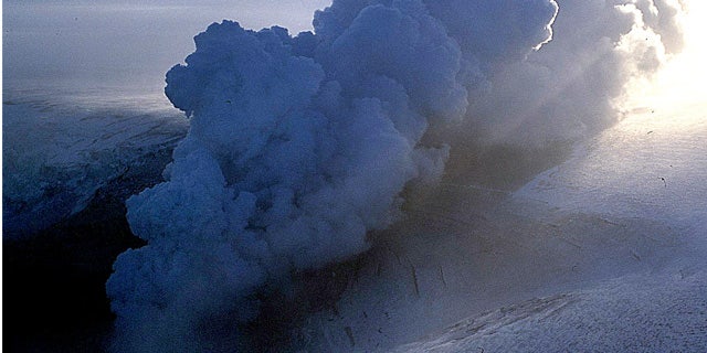 In this 2004 file photo, a cloud of ash erupts from Grimsvotn, a lake in the middle of Vatnajokull, the biggest glacier in Iceland. Torrents of water are pouring from a glacier that sits atop Iceland's most active volcano, an indication that the mountain is growing hotter and may be about to erupt, scientists said Monday, Nov. 1, 2010.