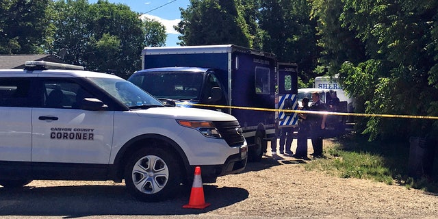 Authorities investigate a scene in Caldwell, Idaho, on Monday, June 19, 2017. Police say three people were found dead inside a home and the Canyon County Sheriff's office is investigating the deaths as possible homicides.