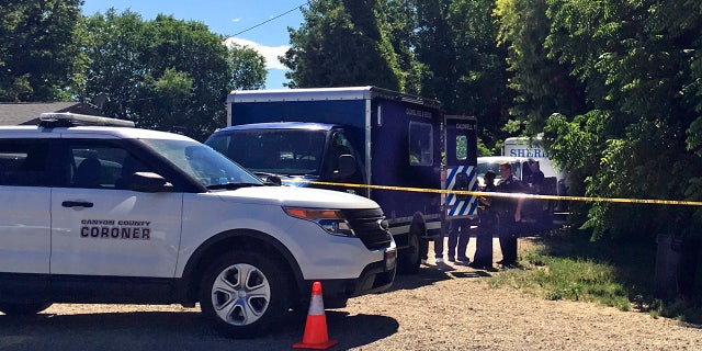 Authorities investigate a scene in Caldwell, Idaho, on Monday, June 19, 2017. Police say three people were found dead inside a home and the Canyon County Sheriff's office is investigating the deaths as possible homicides.