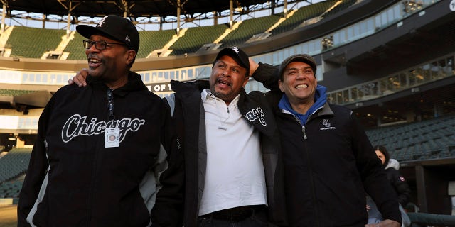 Chicago White Sox groundskeeper Nevest Coleman, center, laughs with friend and fellow grounds crew Harry Smith Jr., left, and friend and now supervisor Jerry Powe.
