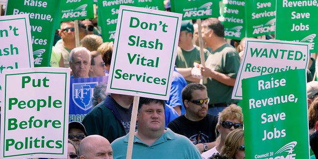 FILE: In this April 21, 2010, file photo, thousands of people, including state union members, state workers, teachers and social service organizations rally to protest budget cuts at the Illinois State Capitol in Springfield, Ill.