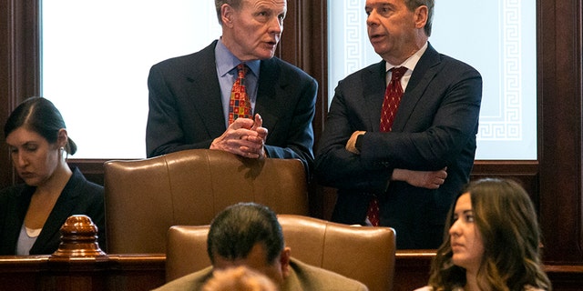 House Speaker Michael Madigan, D-Chicago, left, and Senate President John Cullerton, D-Chicago, talk on the Senate floor Tuesday, July 4, 2017, at the Capitol in Springfield, Ill. The Illinois Senate has OK'd an annual spending plan of $36 billion following a critical vote to raise the income tax rate. If approved by Republican Gov. Bruce Rauner, it would be Illinois' first budget in more than two years. (Rich Saal/The State Journal-Register via AP)