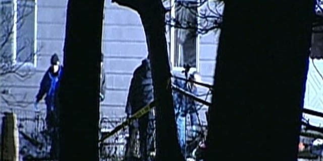 Dec. 17, 2011: Police investigate a crime scene in Illinois where five people were found shot to death.