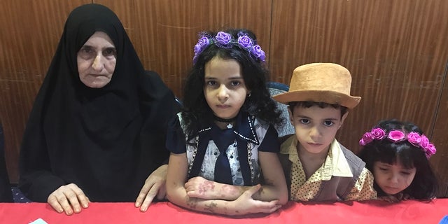 Amina (pictured) is the mother of a prominent Sana' journalist (his three children are pictured with Amina) who has been detained for more than three years. She explained that last time she tried to get close when visiting him, she was banned for seven months