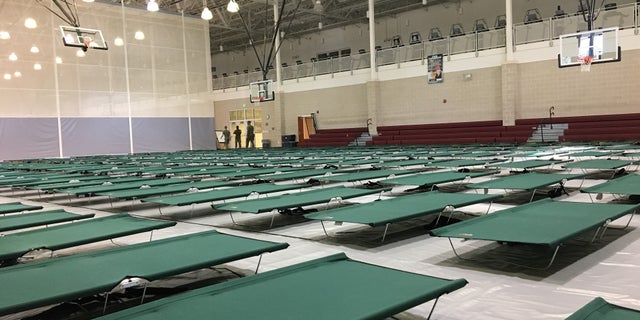 Hundreds of cots fill a gymnasium on Camp Lejeune's base.