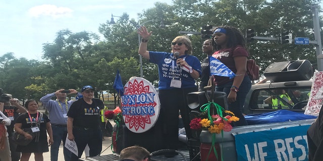 Teachers and union workers march in defiance of the recent Supreme Court decision.