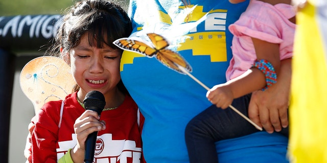 Akemi Vargas, 8, cries as she talks about being separated from her father during an immigrant family separation protest outside the Sandra Day O'Connor US District Court building in Phoenix.