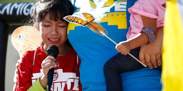 During an immigrant family separation protest in front of the Sandra Day O'Connor U.S. District Court building in Phoenix, Akemi Vargas, 8, cries as she talks about her separation from her father.