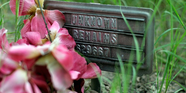 Aug. 23, 2013: A small sign at a cemetery marks the grave site of an unidentified body found on a ranch, in Falfurrias, Texas. Brooks County, home to a Border Patrol checkpoint about an hour north of the border, handled 129 bodies last year of immigrants that died in their attempt to come to the U.S. Brooks County is now trying to improve its services by performing an autopsy on all immigrants and making greater efforts to identify them.