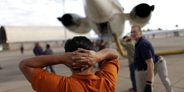 July 10, 2009: A Guatemalan illegal immigrant prepares to board a plane at the Phoenix-Mesa Gateway airport during his deportation process.