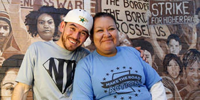 In this Wednesday, Oct. 26, 2016 photo, Guatemalan immigrant and construction worker Mauricio Pelaez-Alvarez, 33, left, poses for a photograph with immigrant rights activist Juana Alvarez, 39, (no relation) after each shared their thoughts with The Associated Press about the upcoming presidential election at Make the Road New York's Brooklyn offices in New York. Although Alvarez has lived in the United States since she emigrated at age 16, and Pelaez-Alvarez has been in the U.S. for ten years, neither can vote in the November election.  (AP Photo/Kathy Willens)